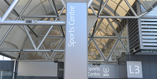 Wayfinding signage, place making and identification for the Sports Centre at Sydney Olympic Park by Minale Tattersfield Australia.